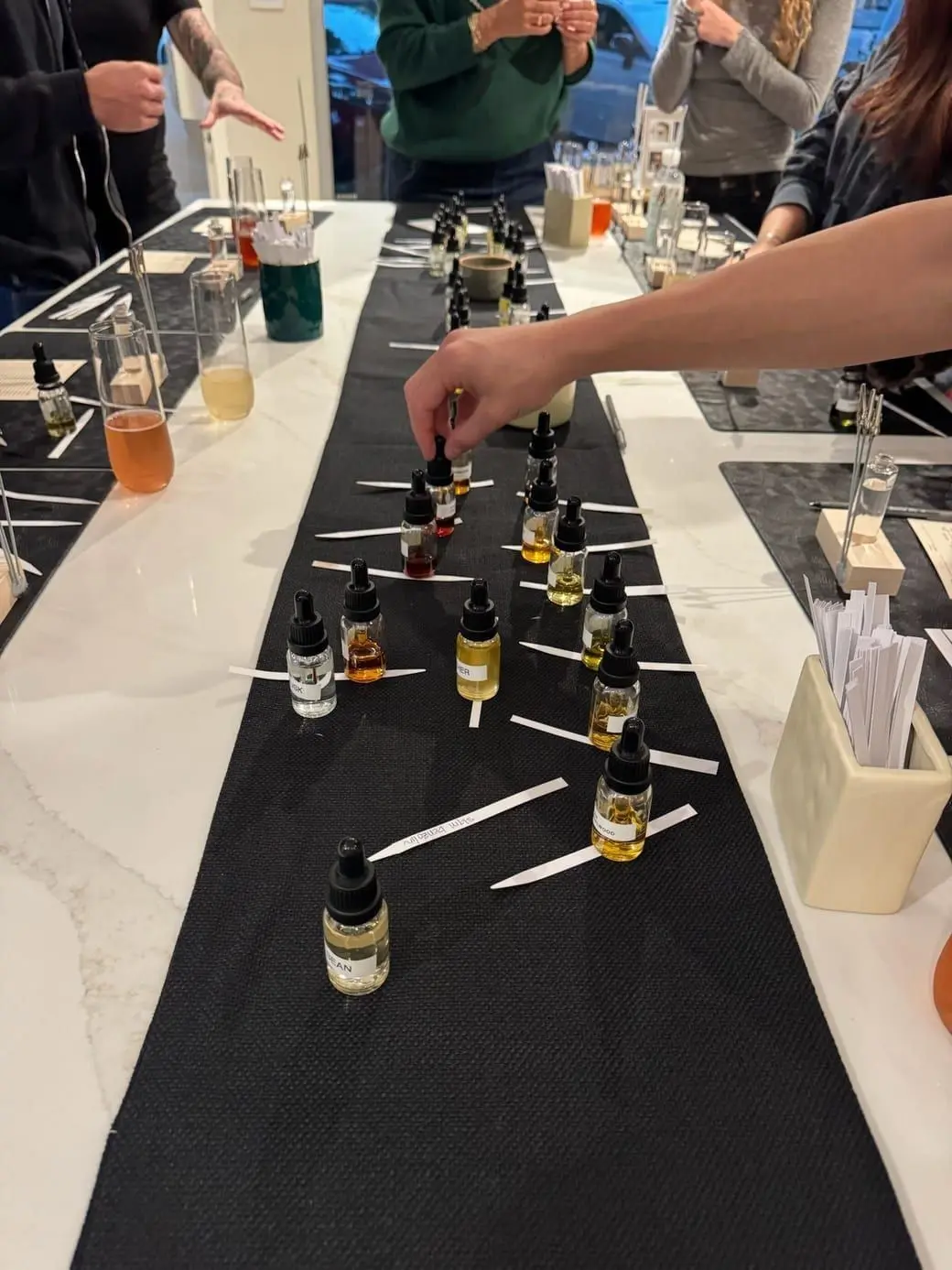 Guests blending custom fragrances at a Drydown workshop